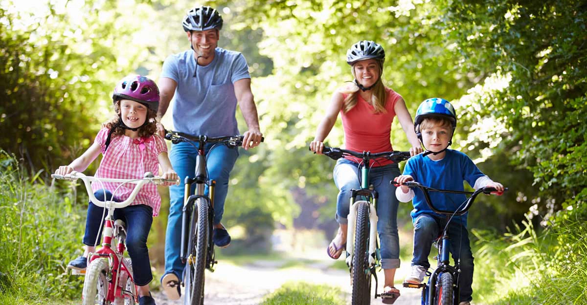 Family of four riding bikes